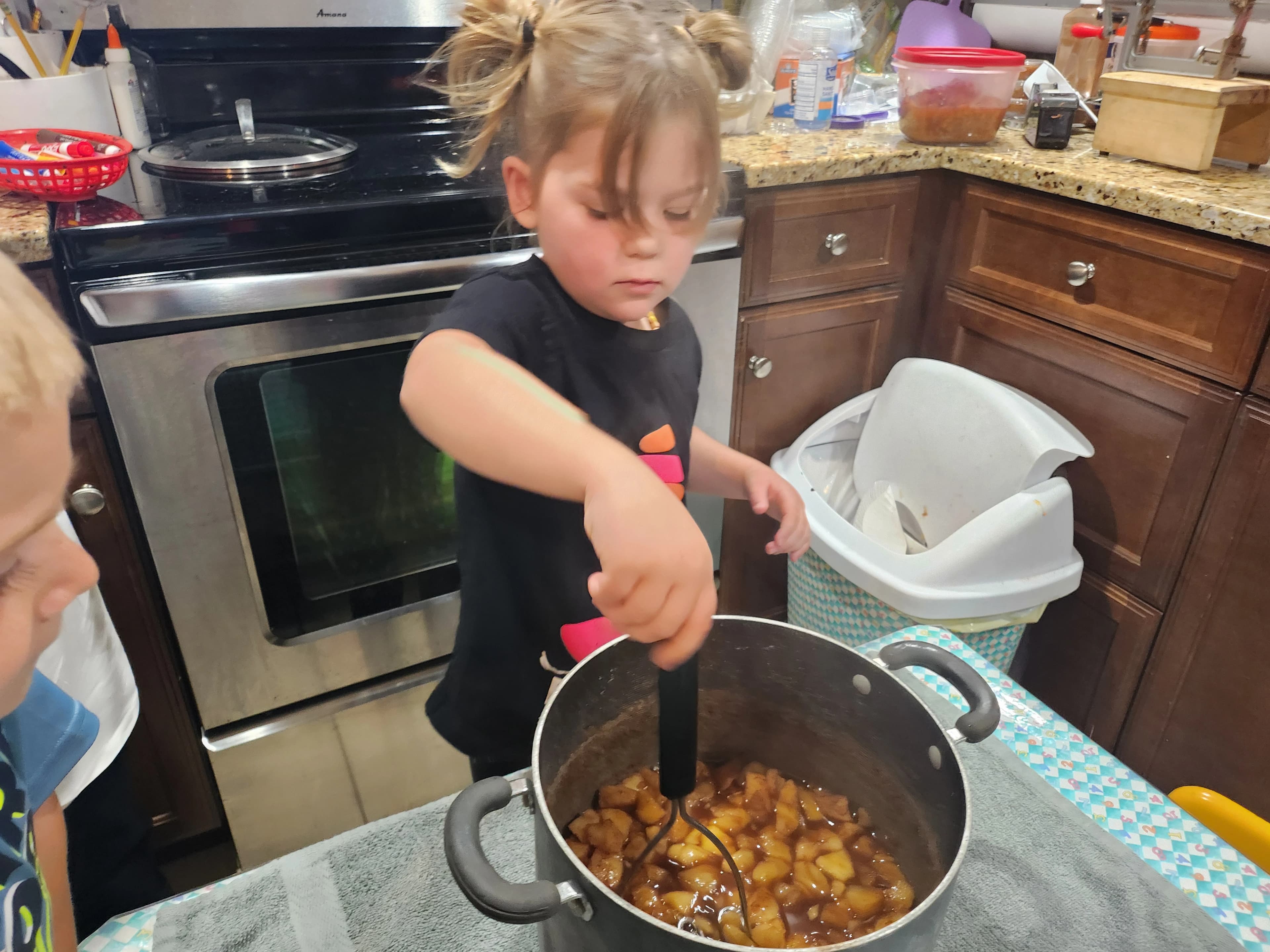 kid mashing apple